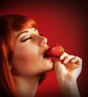 Seductive female with strawberry photo