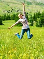 Active sporty woman jumping outdoors photo