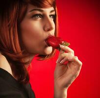 Sexy woman eating strawberry photo