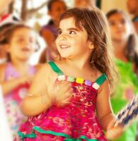 Adorable small girl dancing over blur colors background photo