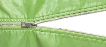 Khaki leather texture and open metal zipper isolated on white background photo