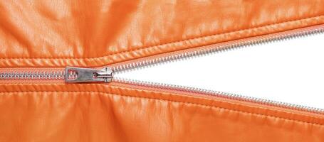 Orange leather texture and open metal zipper isolated on white background photo