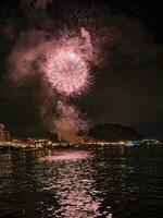 colorful fireworks in the night sky on the seafront of Alicante spain photo