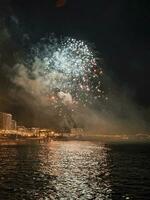 colorful fireworks in the night sky on the seafront of Alicante spain photo