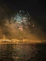 colorful fireworks in the night sky on the seafront of Alicante spain photo