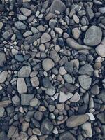 Stone pebbles of rounded fraction as a background texture photo