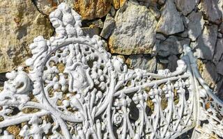 White metal park bench at the roadside Puerto Escondido Mexico. photo