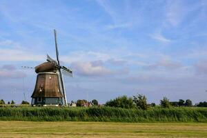 a windmill on a sunny day in the netherlands photo