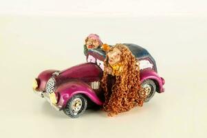 a figurine of two girls in a car photo