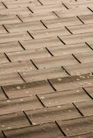 a close up of a roof with brown tiles photo