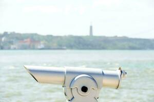 silver telescope with a view of the water photo