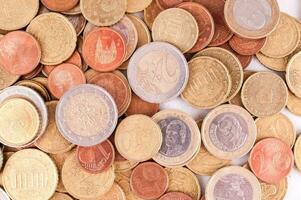 a pile of coins on a white background photo