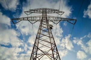 a high voltage power line against a blue sky photo