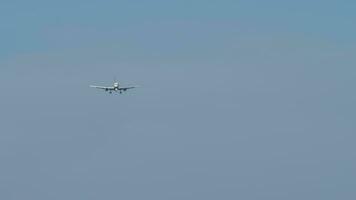 Jet with unrecognizable livery in the sky, long shot. Airliner approaching to land. Commercial plane. Travel and tourism concept video