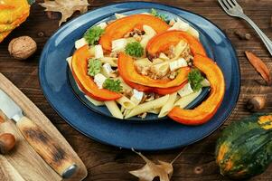 Delicious pumpkin pasta with nuts photo