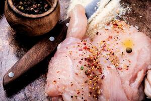 Raw chicken with spices photo