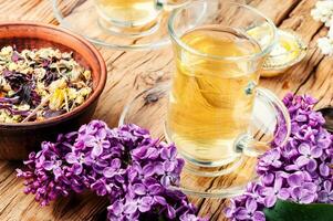 Cup of tea and lilac flowers photo