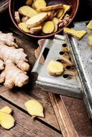 Fresh ginger on rustic background photo