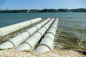 pipes in the water near the shore photo