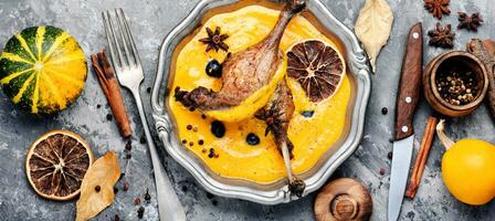 Duck legs in pumpkin puree photo