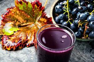 Red grape juice in glass photo