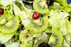 Green vitamin salad of kiwi and herbs. photo