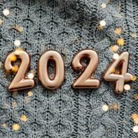 Happy New Year 2024 Postcard. Number 2024 on gray knitted background. Copy space photo