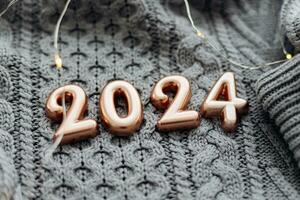 Christmas and New Year Postcard. Number 2024 on knitted gray background. Happy New Year 2024 photo