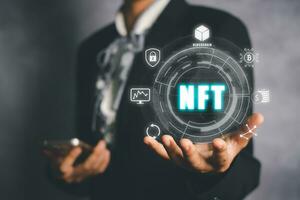 NFT token digital crypto art blockchain technology concept, Person hand holding virtual screen NFT icon background. photo