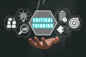 Critical thinking concept, Businessman hand holding critical thinking icon on virtual screen, New ideas and innovations arise and search for answers. photo