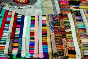 a pile of colorful scarves on display photo