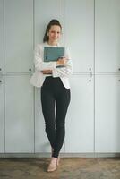 Female business woman standing and analyzing the business report in the office. photo