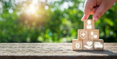 Medicare concept, Man hand holding wooden block on wooden desk with medicare icon on virtual screen. photo