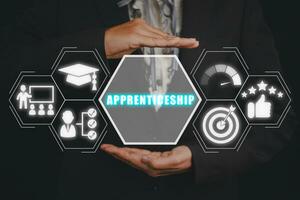 Apprenticeship concept, Businessman hand holding apprenticeship icon on virtual screen. photo
