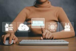 Digital transformation and digitalization technology concept, Young business woman working on computer with virtual screen digital transformation icon on office desk. photo