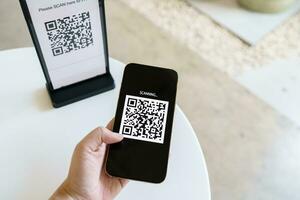 Qr code payment. E wallet. Man scanning tag accepted generate digital pay without money.scanning QR code online shopping cashless payment and verification technology concept. photo