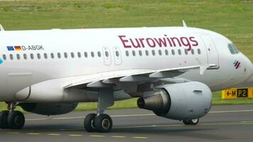 DUSSELDORF, GERMANY JULY 23, 2017 Civil plane Airbus A319, D ABGK of Eurowings taxiing at Dusseldorf airport, side view. Passenger flight on the taxiway or runway. Travel concept video