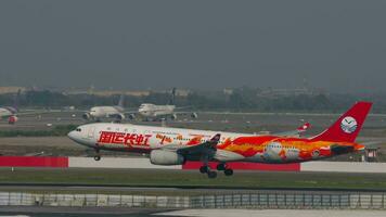 BANGKOK, THAILAND MARCH 01, 2023 Airbus A330, B 5960 of Sichuan Airlines with Changhong Livery landing and touching the runway at Suvarnabhumi Airport, side view. Aircraft arriving. video