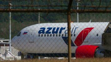 PHUKET, THAILAND JANUARY 23, 2023 Middle shot, Boeing 767 of Azur Air taxiing at Phuket Airport. Airfield runway. Passenger aircraft on the taxiway. Travel concept video