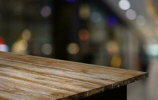 Empty wooden table in front of abstract blurred background of coffee shop . can be used for display or montage your products.Mock up for display of product photo