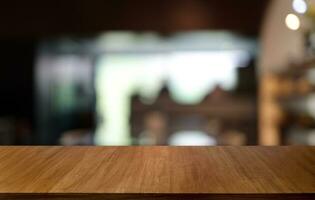 Empty wooden table in front of abstract blurred background of coffee shop . can be used for display or montage your products.Mock up for display of product photo