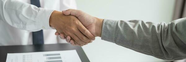 Businessman shaking hands successful making a deal. mans handshake. Business partnership meeting concept photo