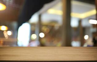 Empty wooden table in front of abstract blurred background of coffee shop . can be used for display or montage your products.Mock up for display of product photo