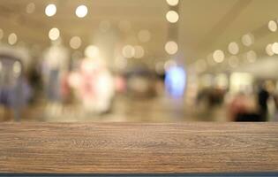 Wood table top in front of abstract blurred background. Empty wooden table space for text marketing promotion. blank wood table surface copy space photo