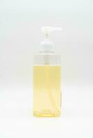 Yellow liquid soap or shampoo by pouring it from a refill to reduce plastic waste. Sustainable Zero Waste. photo