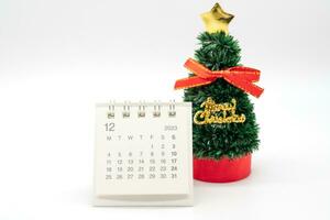 December's calendar and Christmas Tree isolated on white background. Christmas background. photo