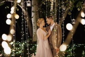 night wedding ceremony of the newlyweds in a country cottage photo