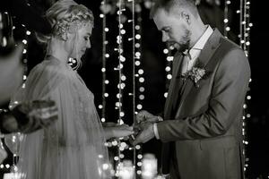 night wedding ceremony of the newlyweds in a country cottage photo