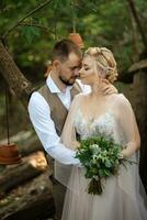 wedding walk of the bride and groom in a coniferous in elven accessories photo