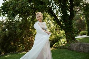 portrait of a happy bride in a light light dress in  wearing elven accessories photo